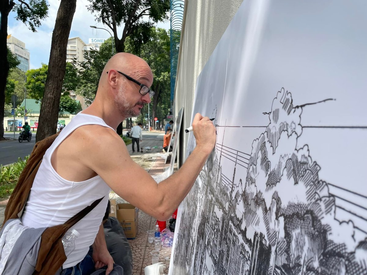 The artist revises his works before hanging on the wall.This project is part of Fawcetts Preserving the memory of the city through sketches program, documenting the changes in HCMC in more than 10 years of his time living here.The artist said he spent many years observing the scenery of the city and recording it using ink drawing technique on large paper.