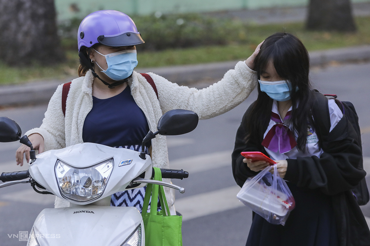 A parent sees her daughter off to school.