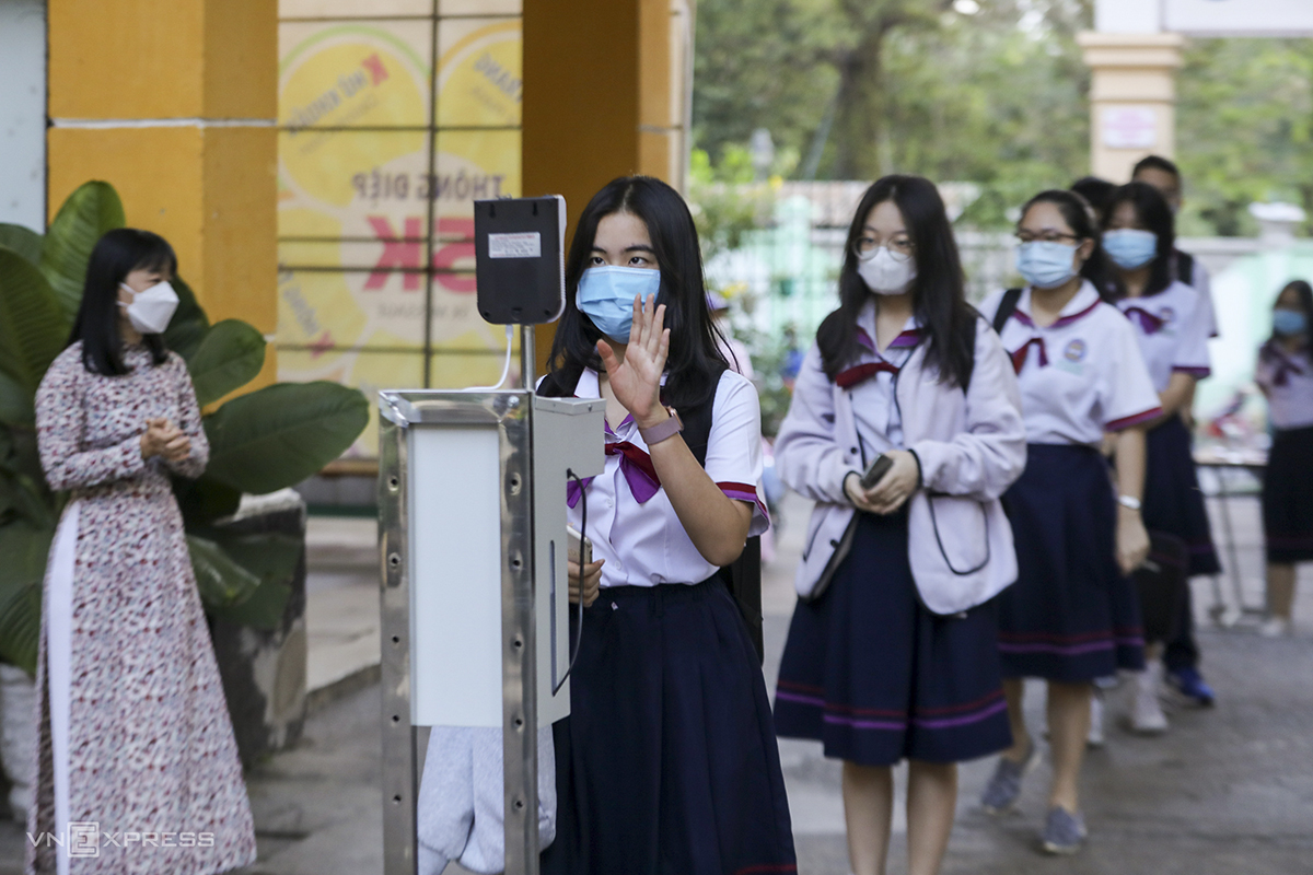 Students have their body temperature checked at entrance.