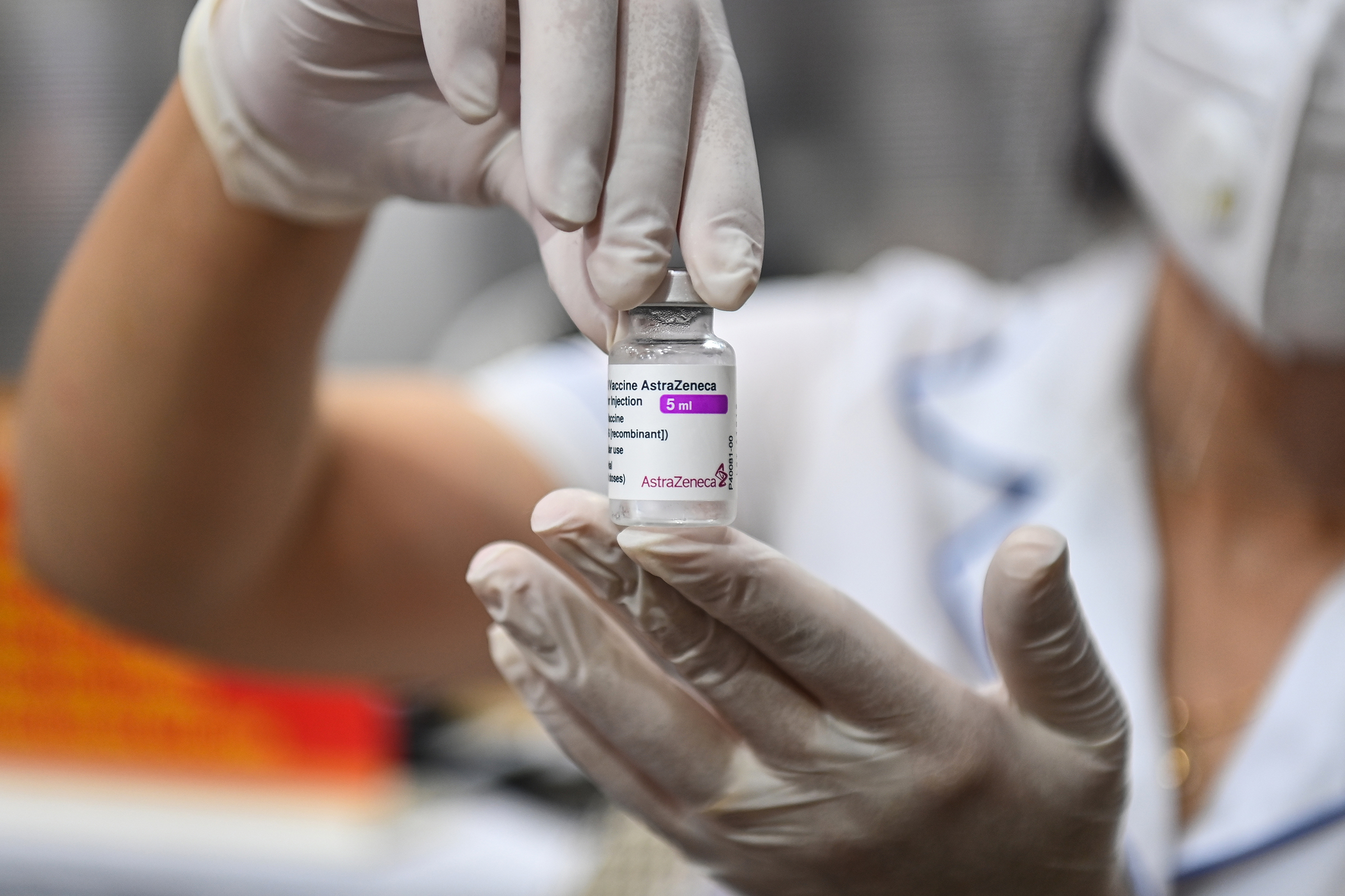A medic holds a vial of the AstraZeneca Covid-19 vaccine in Hanoi. Photo by VnExpress/Giang Huy