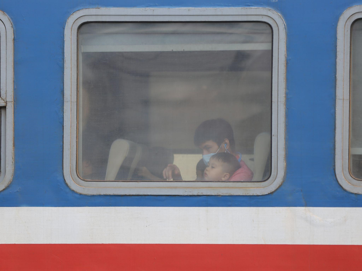 Seek help - A father-and-son pair coming back home on a late train. Photo courtesy of Swinburne Vietnam