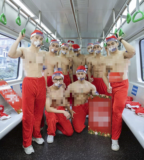 A group of shirtless men wearing Santa Clause pants on the Cat Linh - Ha Dong metro line, December 2021. Photo by Vua Nem