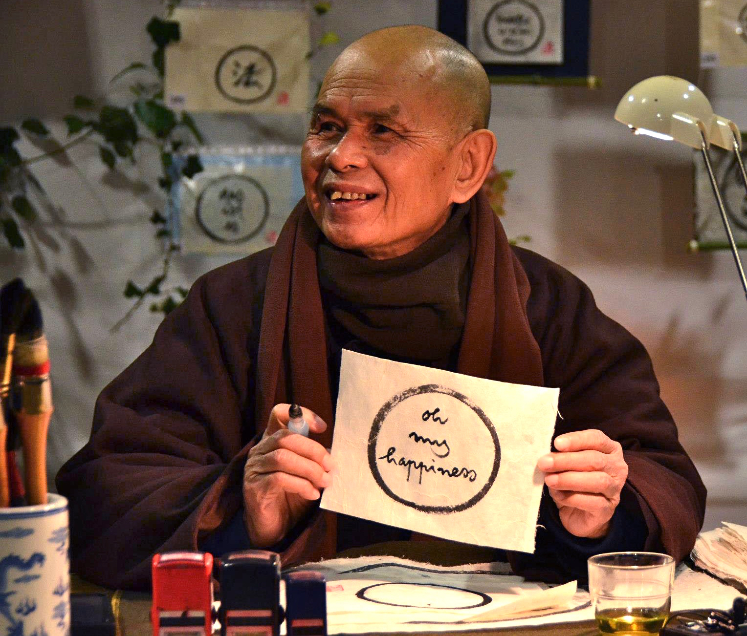 Zen Master Thich Nhat Hanh writes calligraphies at the Plum Village in France in 2013. Photo courtesy of Plum Village