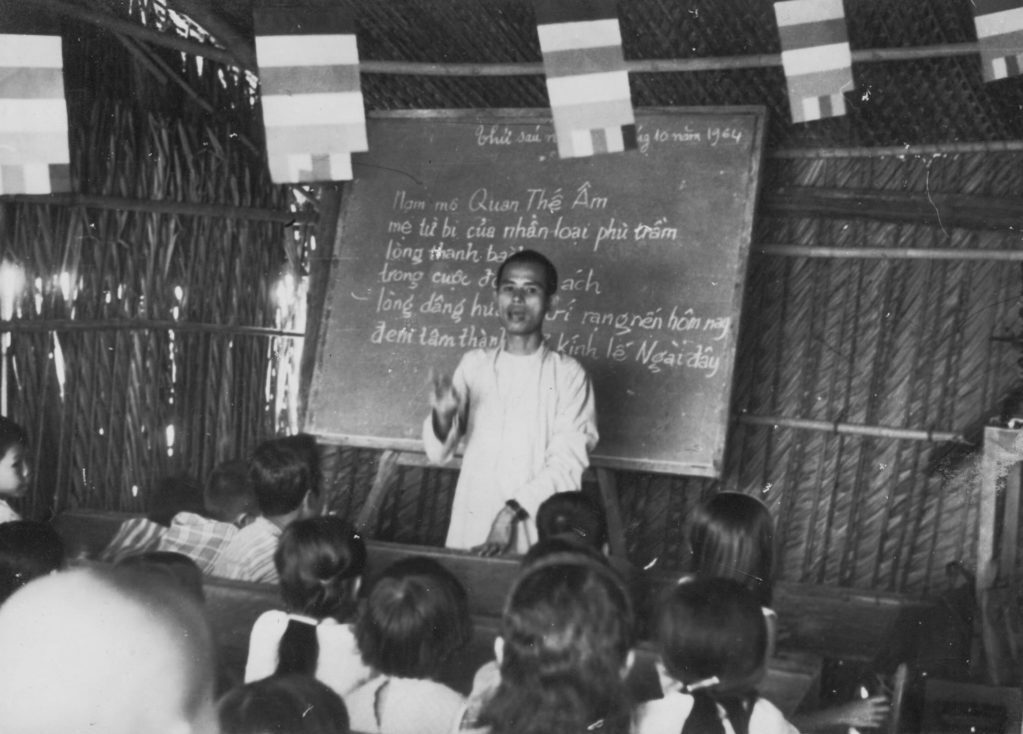 Thich Nhat Hanh teaches children to read and write in 1964. Photo courtesy of the Plum Village Community of Engaged Buddhism