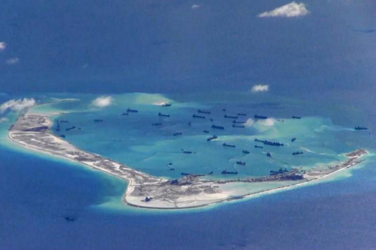 Chinese dredging vessels purportedly seen in the waters around Mischief Reef in the disputed Spratly Islands in the South China Sea, May 2015. U.S. Navy/Handout via Reuters
