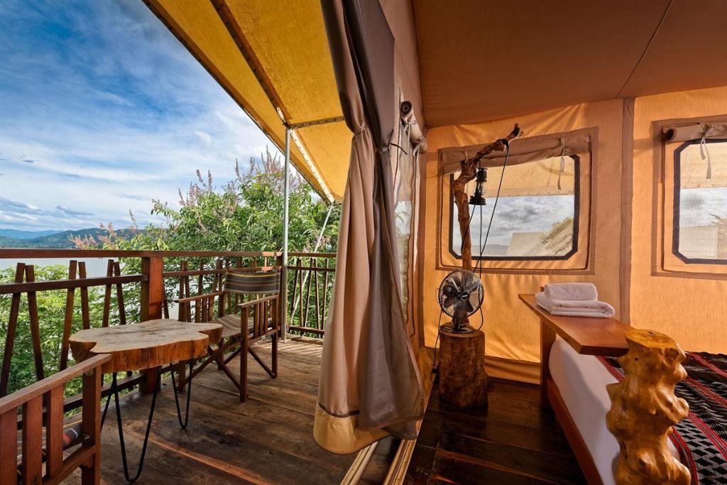 Tents are designed with modern furniture and overlook Lak Lake. Photo courtesy of Lak Tented Camp