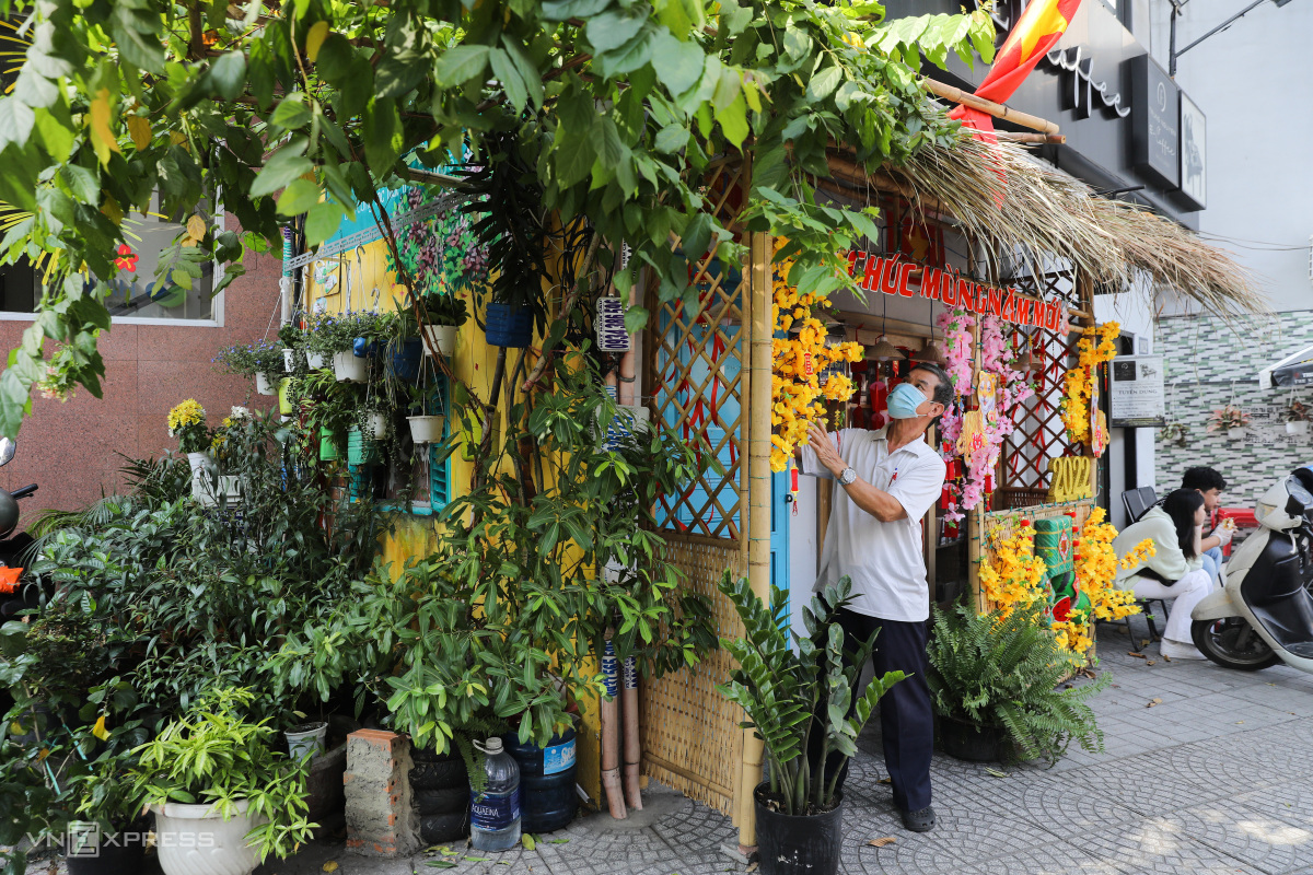 Dinh Xuan Du, head of neighborhood 5, is here every day to take care of his spring landscape corner at alley 162 on Bui Thi Xuan Street. He explained that because the alley was narrow, decorations were placed at the alleys entrance. We take advantage of the tree here and added a thatched roof and some simple decoration to add more festive spirit to the neighborhood, Du explained.