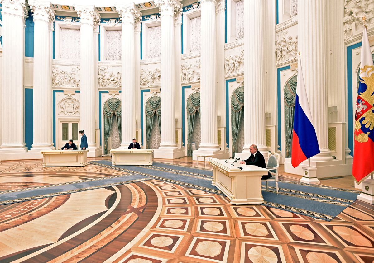 Russian President Vladimir Putin attends a ceremony to sign documents, including a decree recognising two Russian-backed breakaway regions in eastern Ukraine as independent entities, with leaders of the self-proclaimed republics Leonid Pasechnik and Denis Pushilin seen in the background, in Moscow, Russia, in this picture released February 21,