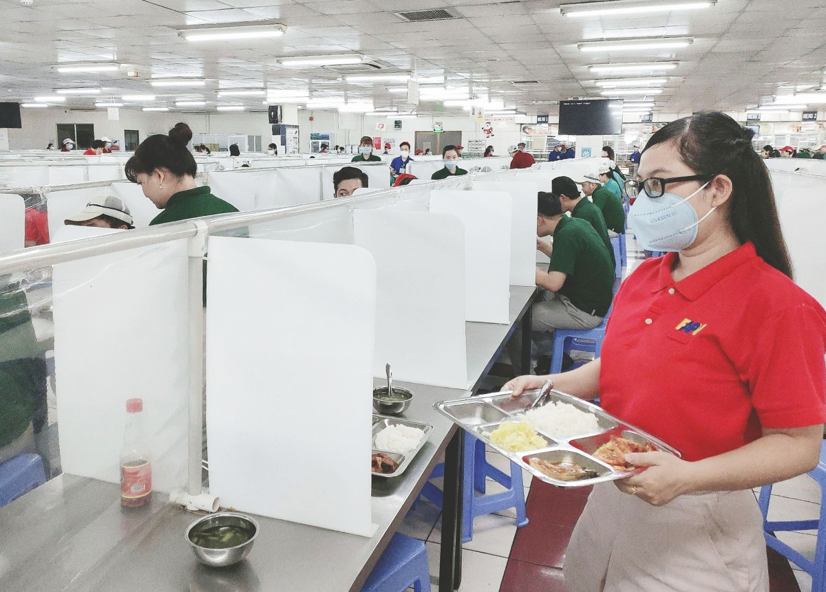 Workers of Furukawa Automotive Parts Vietnam Co., Ltd (FAPV) in HCMCs District 7 have lunch as they stay to work during the Tet break, February 2022. Photo by VnExpress/An Phuong