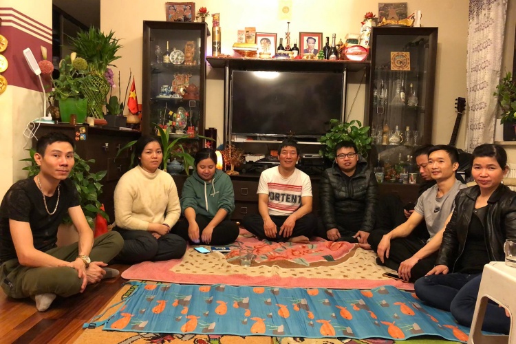 Nguyen Quoc Phuong, white T-shirt, welcomes Vietnamese from Uraine in his home in March 2. Photo courtesy of Nguyen Quoc Phuong