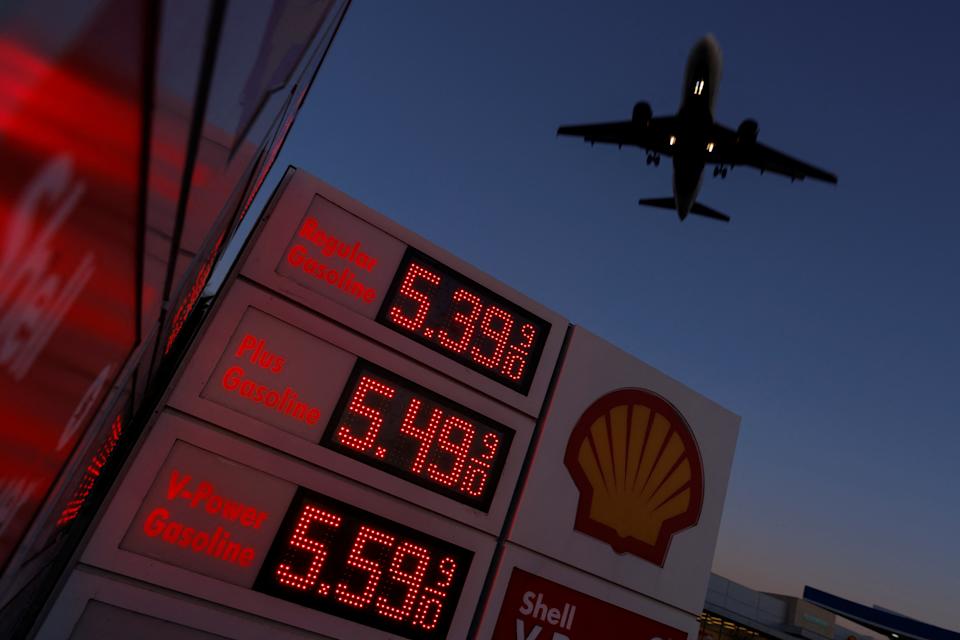 An aircraft flies over a sign displaying current gas prices as it approaches to land in San Diego, California, U.S., February 28, 2022. Photo by Reuters