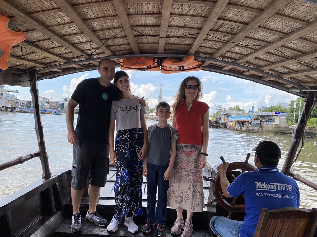 The British family pose for a group photo during their trip to the Mekong Delta, March 2022 after Vietnam reopens international tourism. Photo courtesy of Huynh Duy Hien