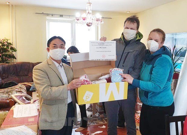 Trinh Tan, L, gives masks to support local people in Ostrava in the Covid-19 fight in 2020. Photo by Vietnam News Agency
