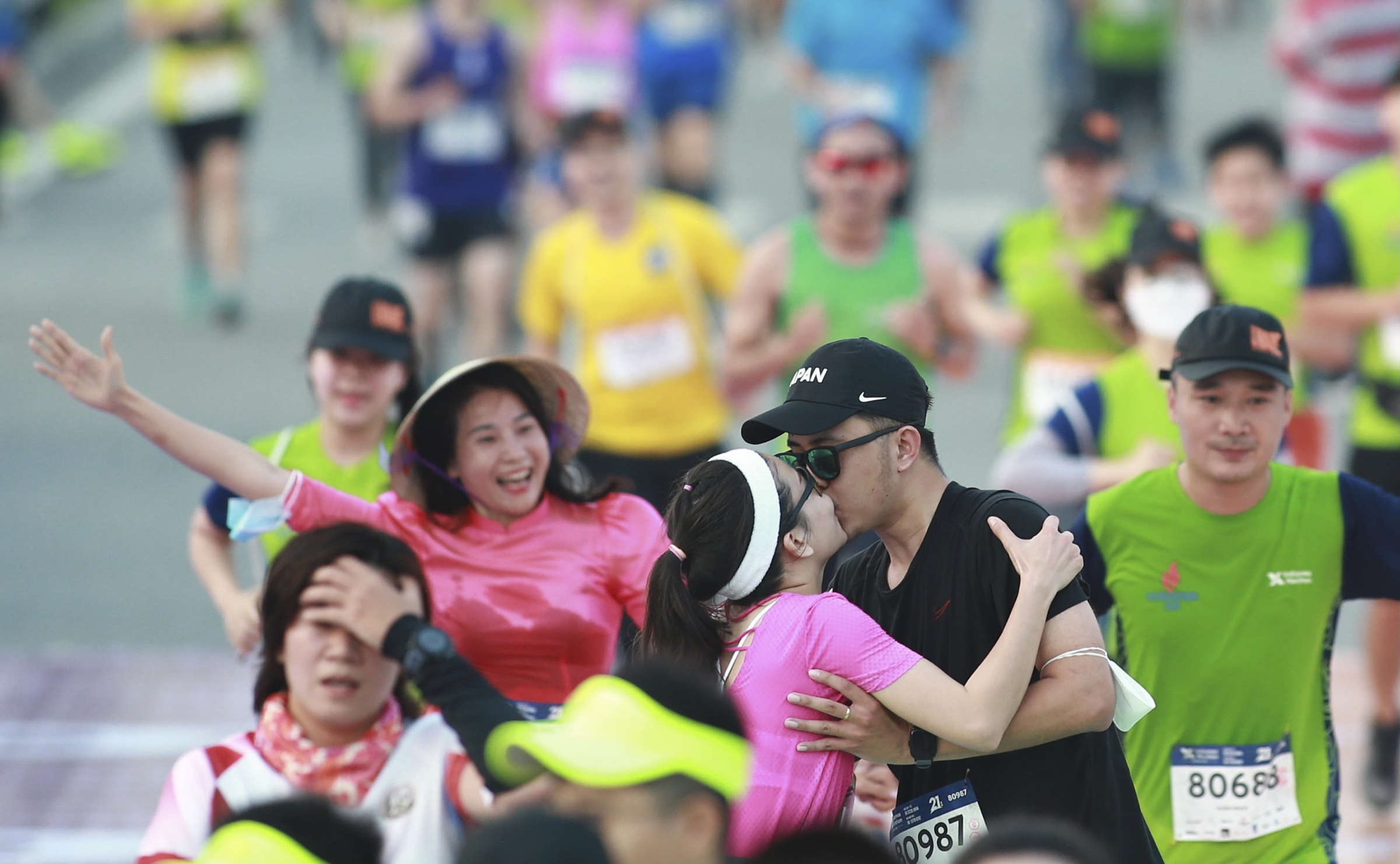 A couple kiss after finishing their 21-kilometer run.