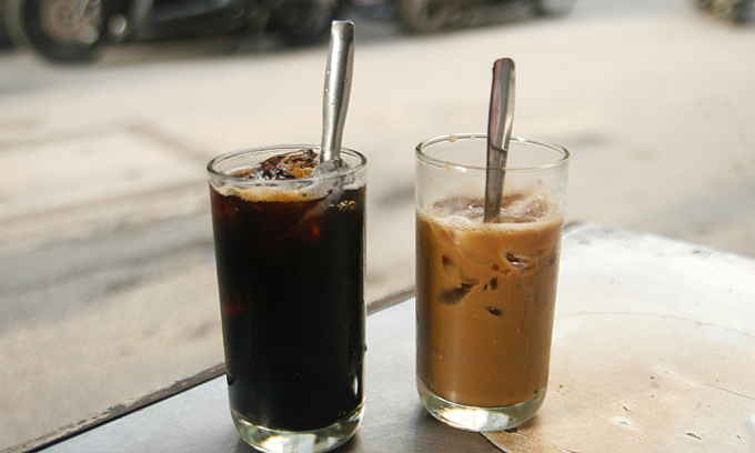 Two cups of iced black coffee (L) and iced coffee with condensed milk at a shop on Phan Dinh Phung Street in HCMC. Photo by VnExpress/Di Vy