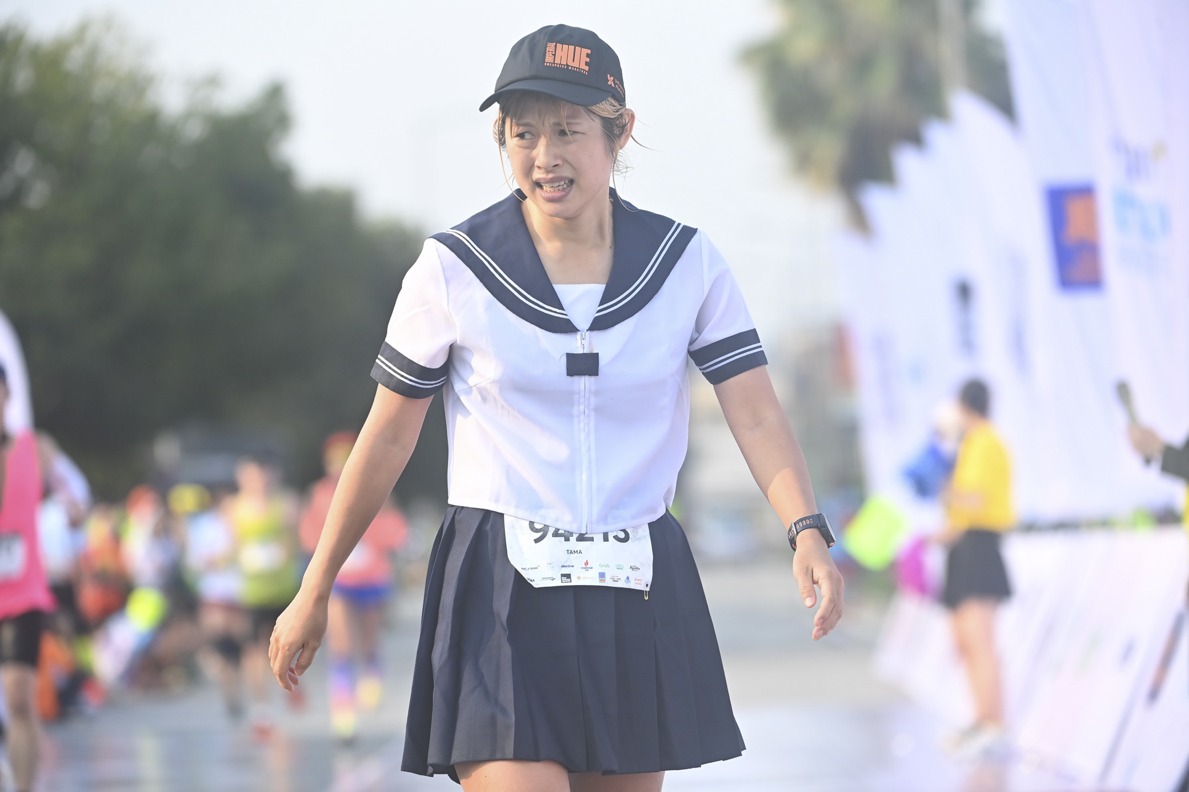 A woman in Sailor Moon costume walks away after finishing her 42-km run.