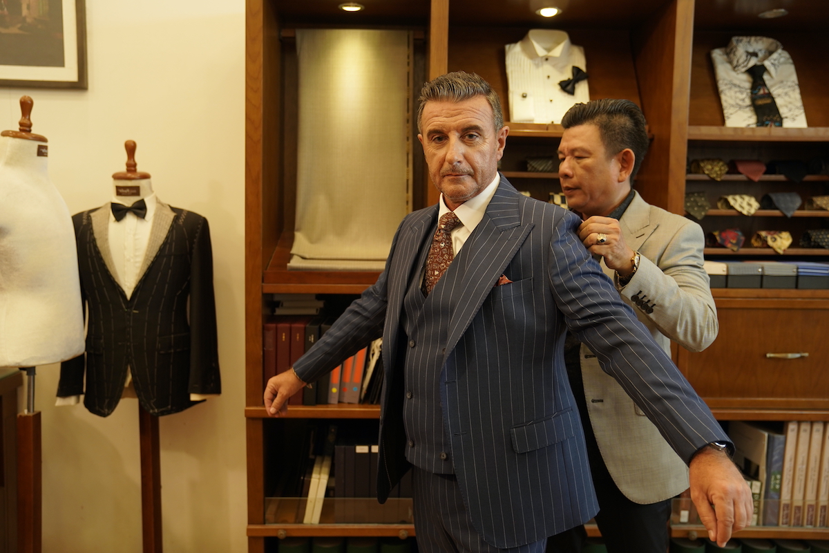 A customer has a new suit measured at Nhut Tailor in District 1, HCMC. Photo by Dennis Khng