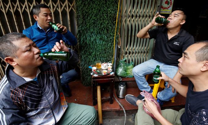Men drink beer at a roadside restaurant in Hanoi, Vietnam. Photo by Reuters