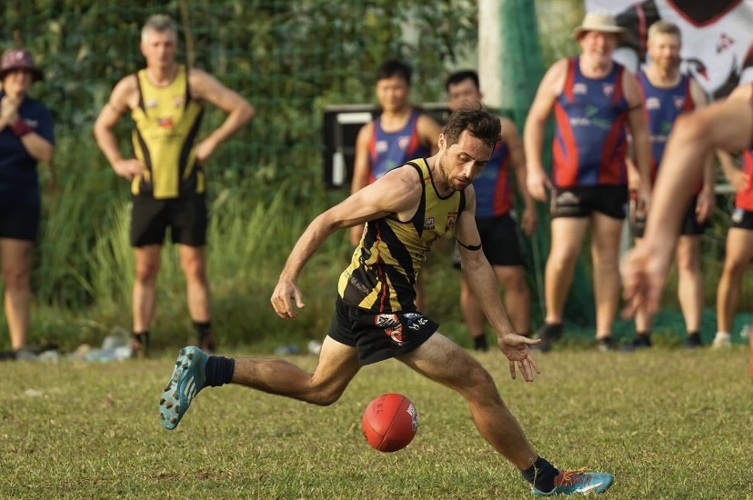 Jason O’Cathrin collects a loose ball whilst playing Australian Rules Football.