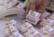 Gold prices inch down