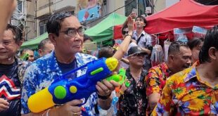 Thai PM gets a drenching in surprise water fight appearance