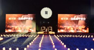 People take part in a candlelight vigil in commemoration of victims of the Nanjing Massacre on the occasion of the tenth National Memorial Day