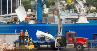 Presumed human remains and shattered Titanic submersible returned to shore