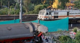 India investigates rail disaster as trains crawl through crash site