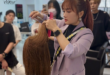 Hairstylist teaching precision haircut to students