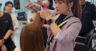 Hairstylist teaching precision haircut to students
